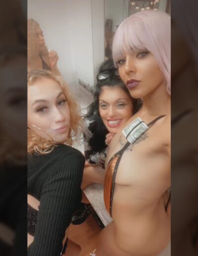 4 Women having fun with a dollar in one of there bra straps
